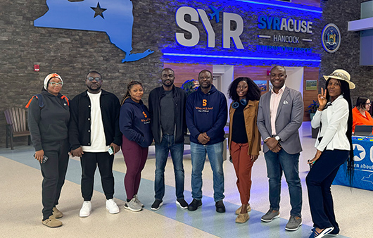 Students posing at the Syracuse Hancock International Airport