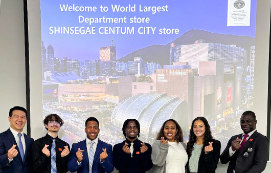 Students posing in front of a Shinsegae Centrum City store picture