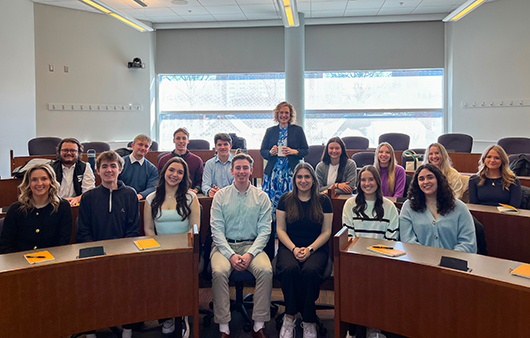 Kenya team students posing with Professor Wimer in a classroom