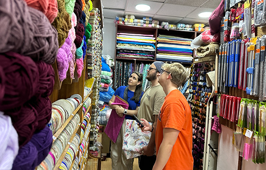 Students looking at fabrics at Sandstorm