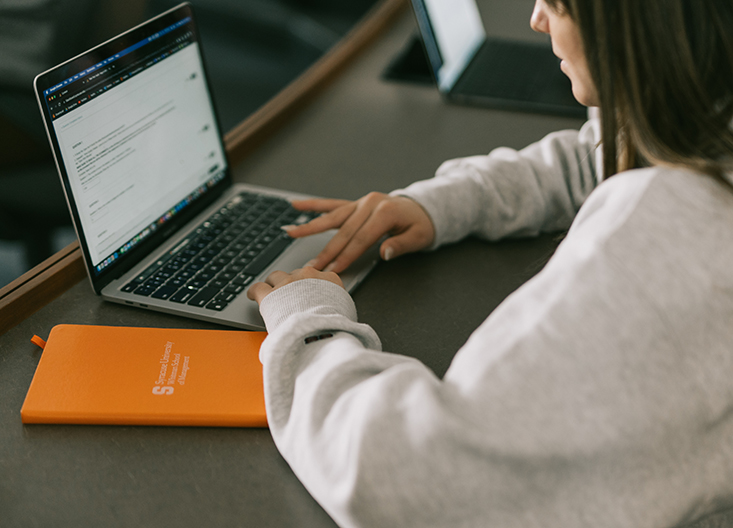 Student typing on her laptop