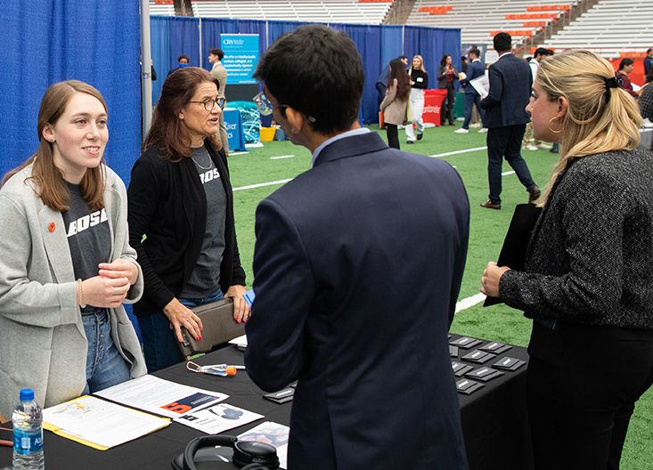 Students talking to recruiters at a career fair on campus