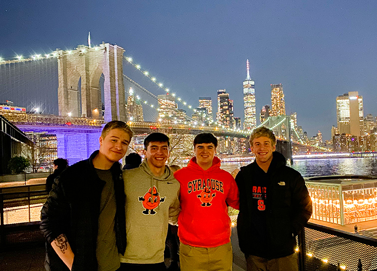 CC_exploration_bridge_733x528 Students posing with nighttime skyline in background