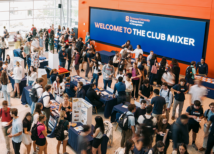Flaum Grand Hall full of students and screen saying Welcome to the club mixer