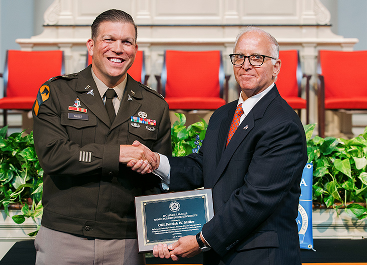 Thomas Constable gives certificate to graduating student