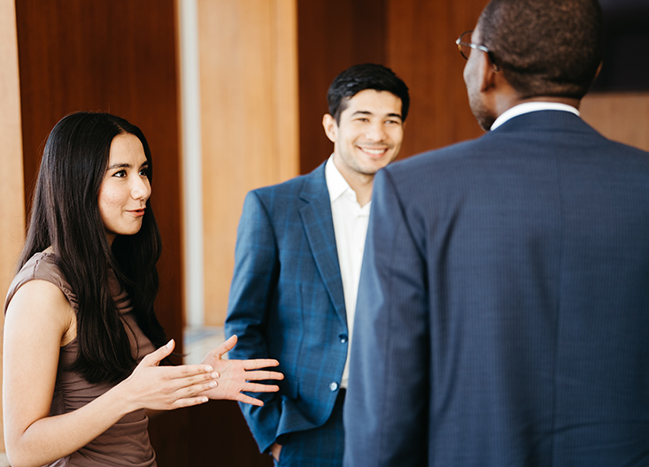 Two students talking to professor