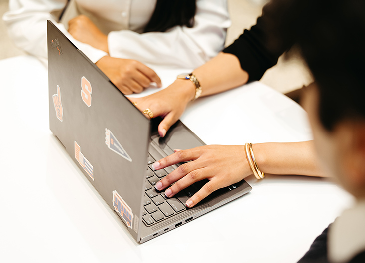 Group of students working in front of laptop