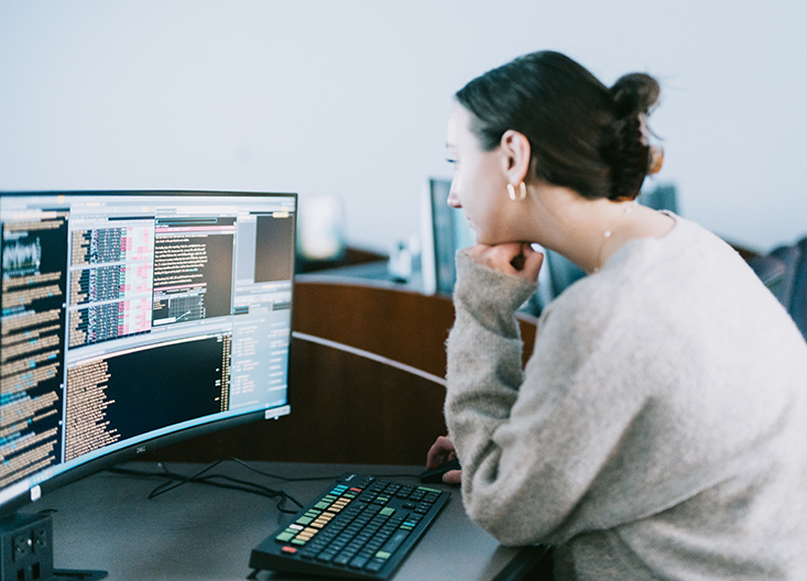 Student looking at computer screen showing Bloomberg terminal