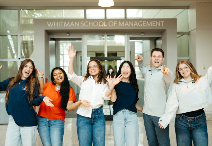 Students in front of Whitman School of Management Sign