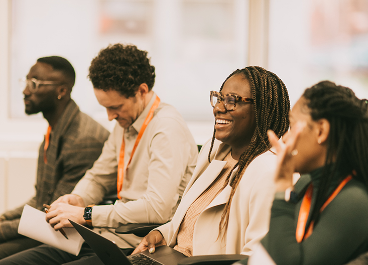 Graduate students laughing during a class