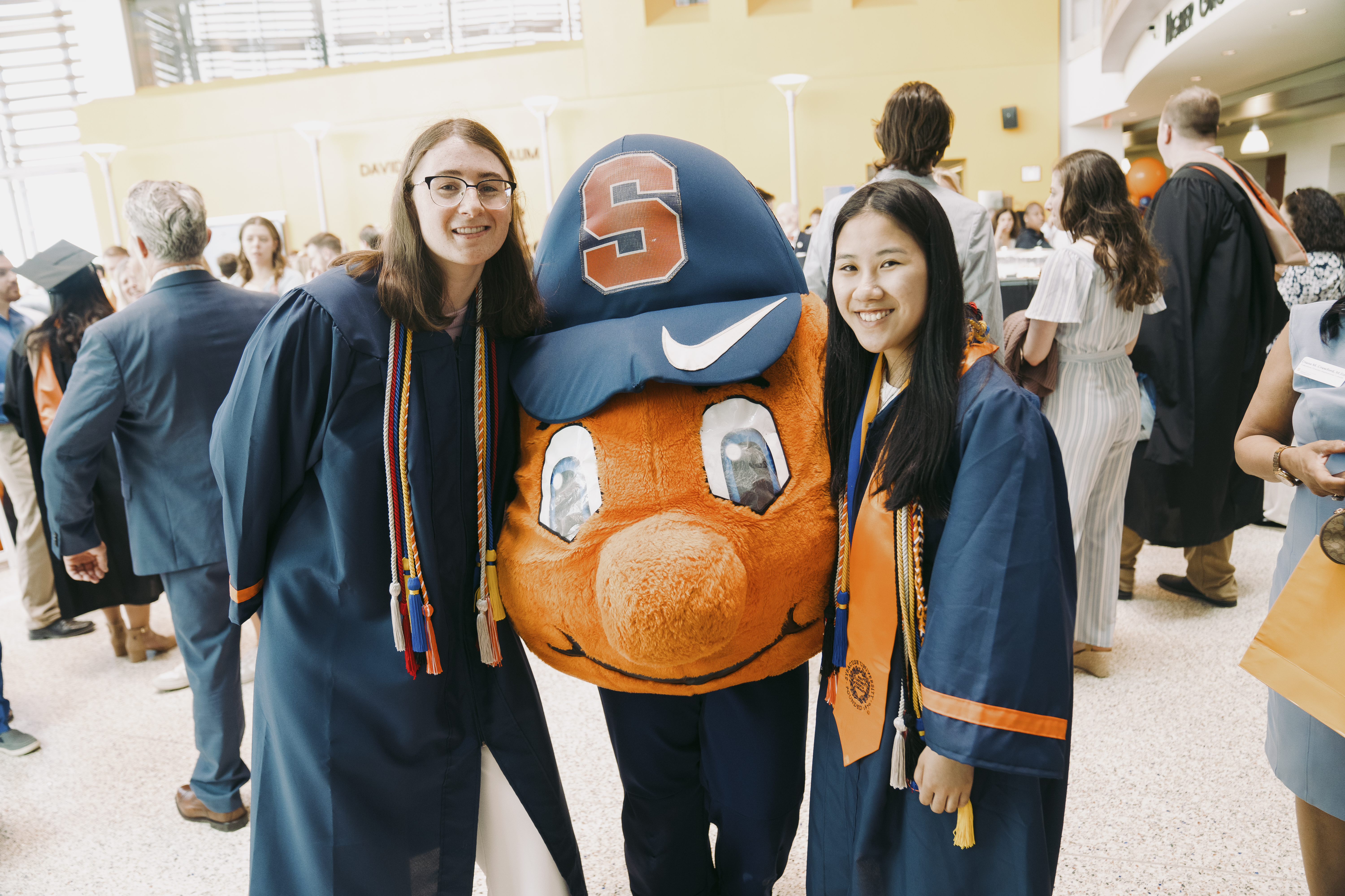 Graduating students with Otto the Orange