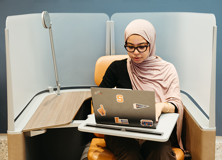 Student on laptop in study pod