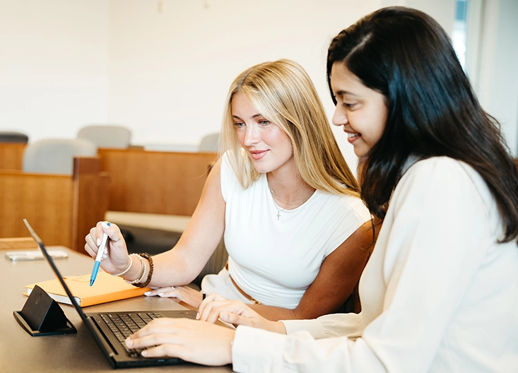 Two students looking at laptop