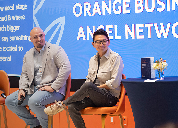 Two panelists on stage during launch of OBAN
