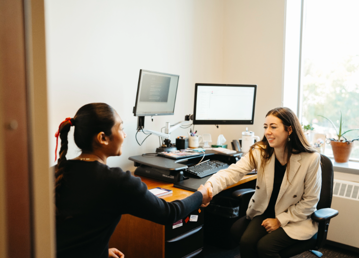 Student shaking hand with Whitman staff