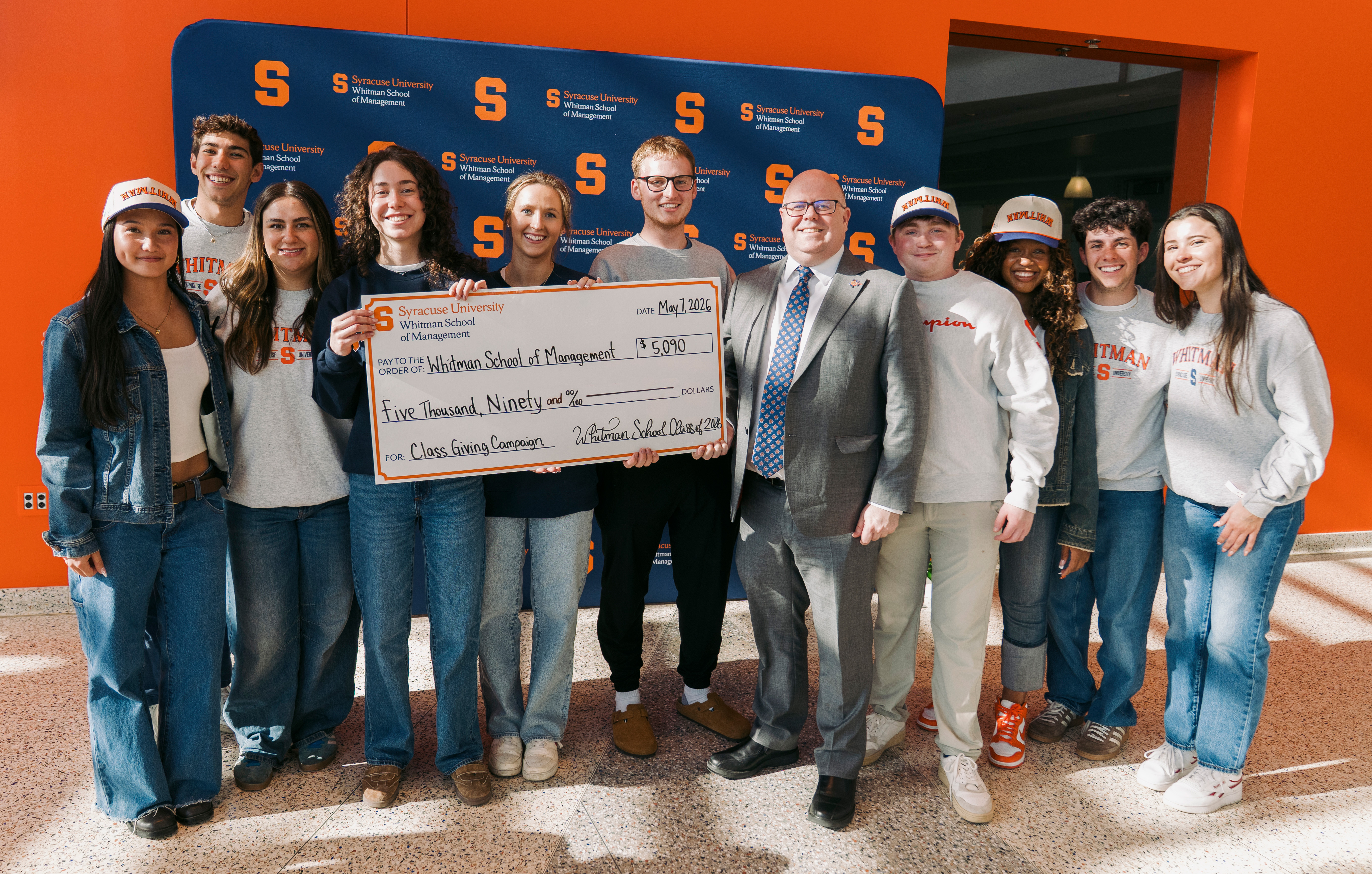 The 2026 Whitman Class Giving Committee presenting Interim Dean Alex McKelvie with a ceremonial check