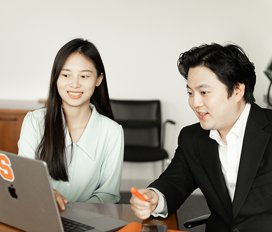 PhD students looking at a laptop