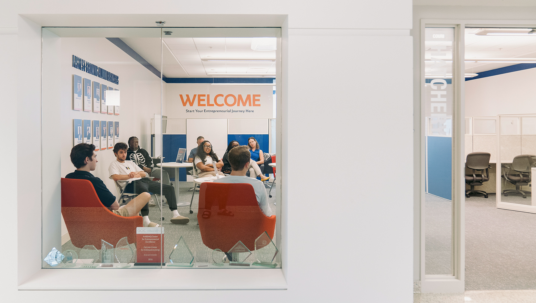 Couri Hatchery space from the outside, with participants in fireside chat seen through window