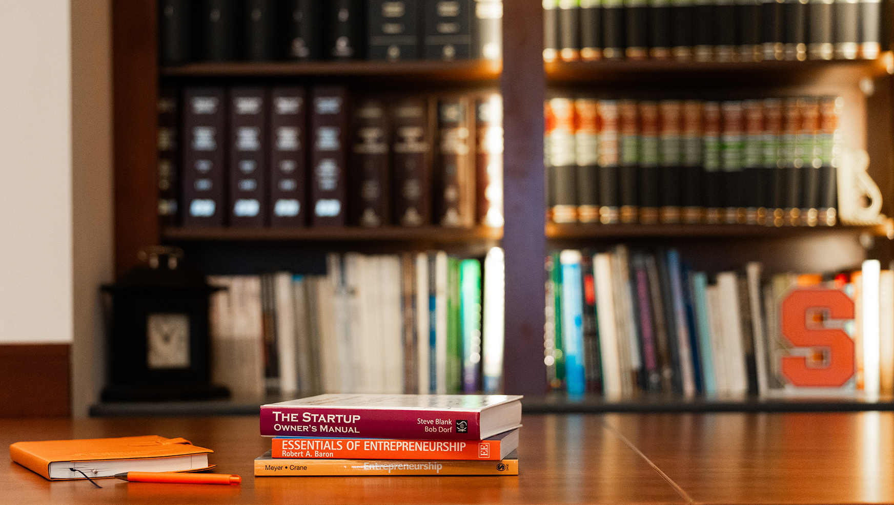 Entrepreneurship books in front of bookshelf