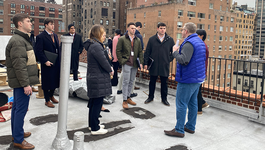 Peter Hungerford talking to students on a rooftop in New York City