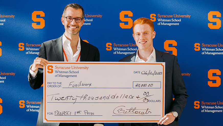 Cristiano Bellavitis and Aaron Krause posing with oversized check