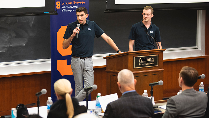 Students presenting in front of panel of judges