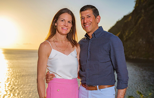 Debbie and Ajay Nagpal posing at sunset