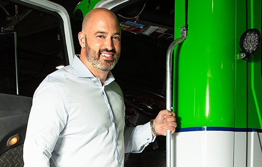 Greg Lettieri posing with one of his company's waste haulers