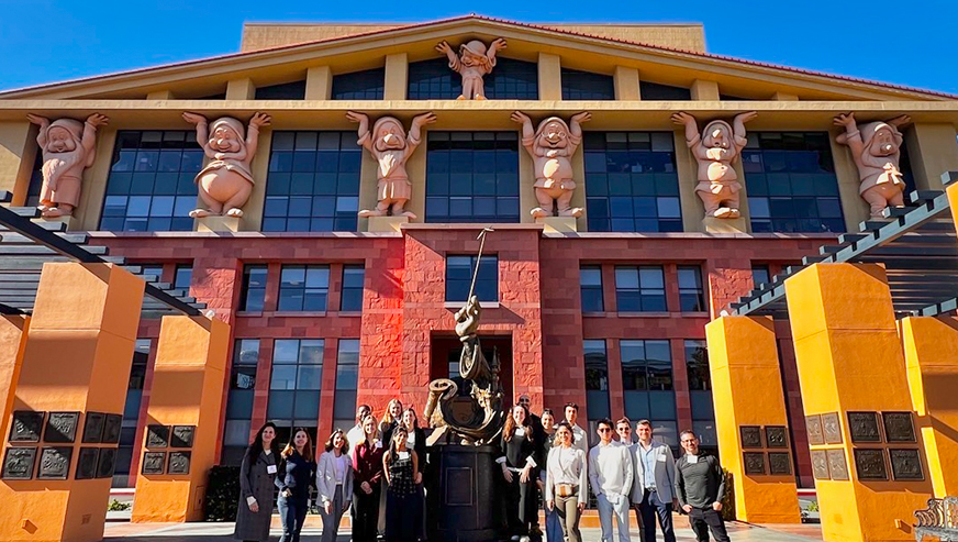Student posing in front of a Disney building