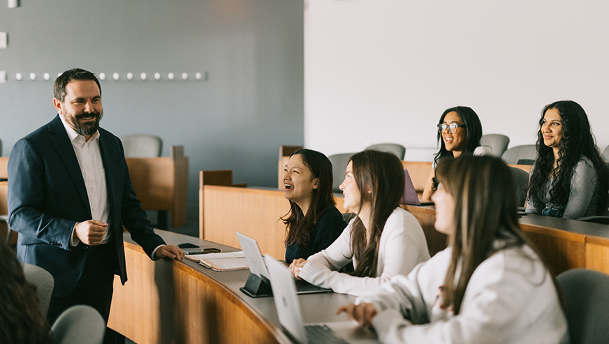 Cameron Miller in a classroom with students