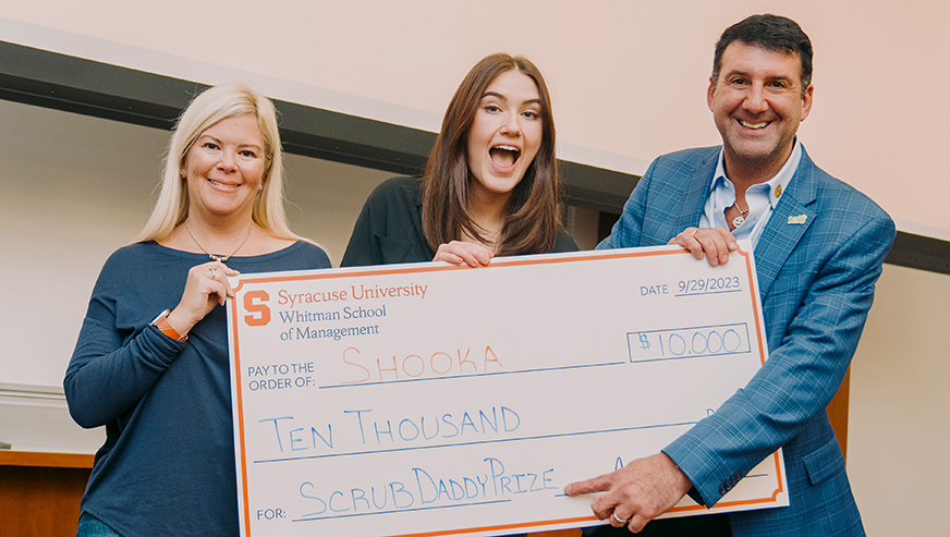 Natasha Brao and Aaron Krause posing with the oversized $10,000 check.