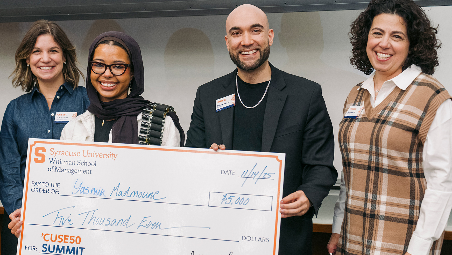 Yasmin Madmoune posing with her check