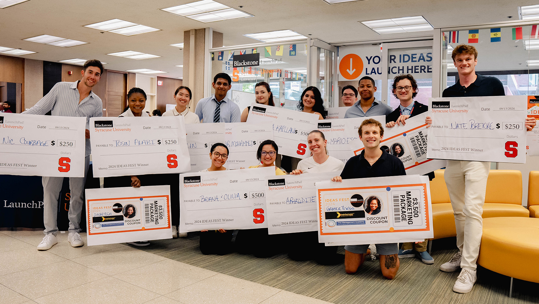 Big group of winners posing with their oversized checks during Ideafest