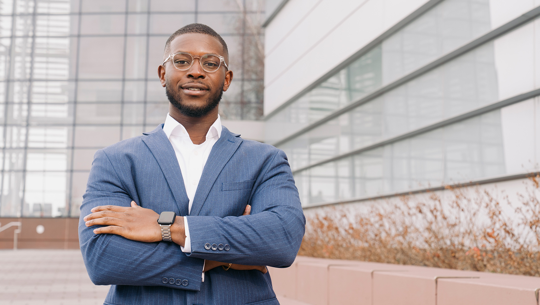 Online MBA student posing in front of the Whitman school building