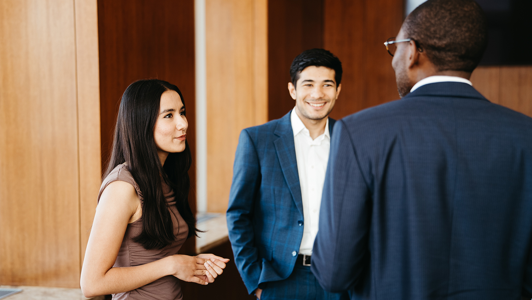 Two students chatting with professor