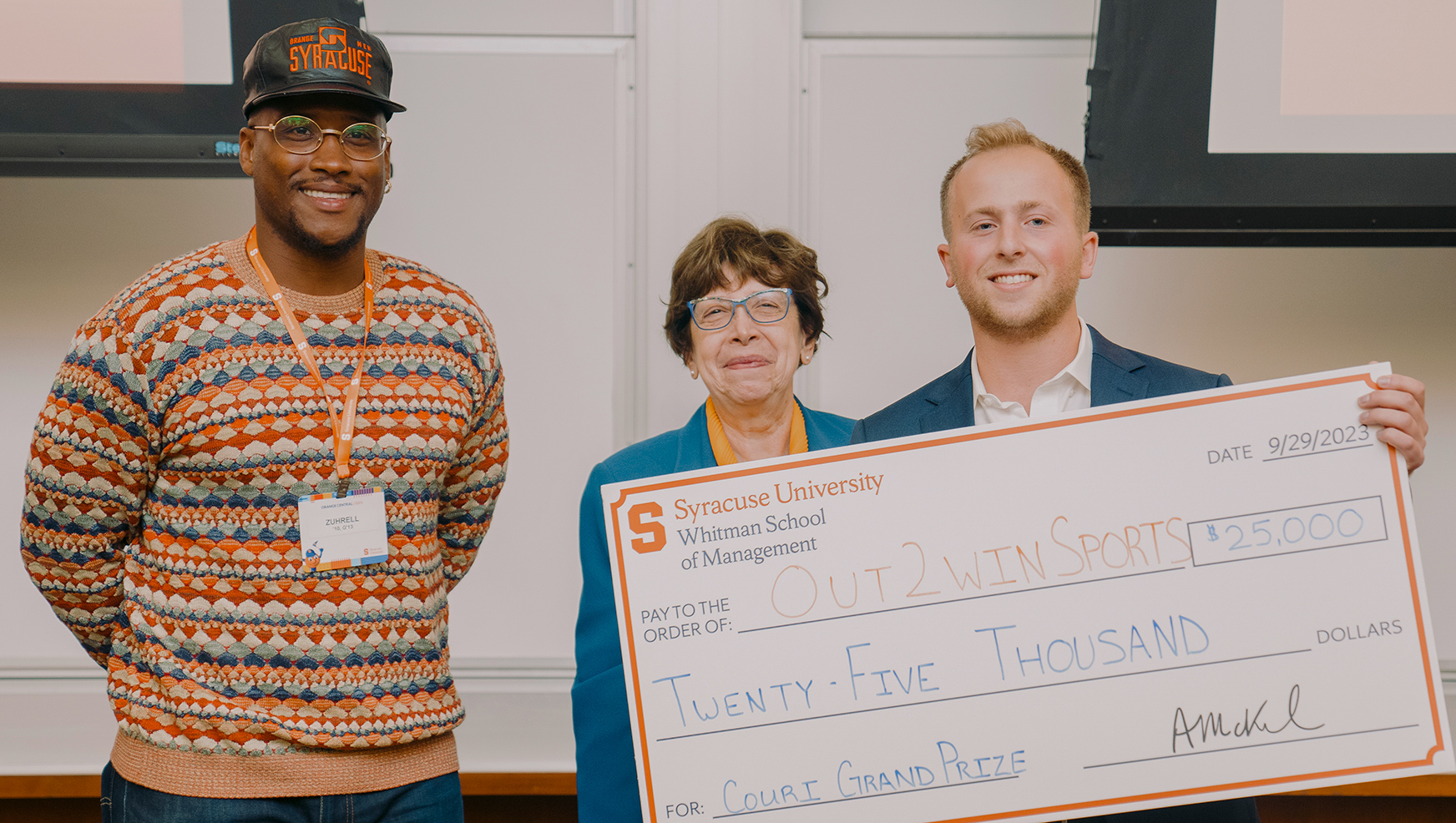 Derrell Smith, Maria Minniti and Jack Adler posing with $25,000 check