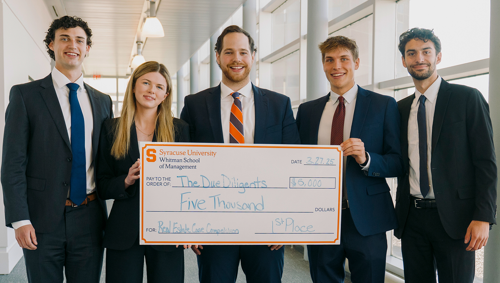 The students of the winning team poses with the oversized check