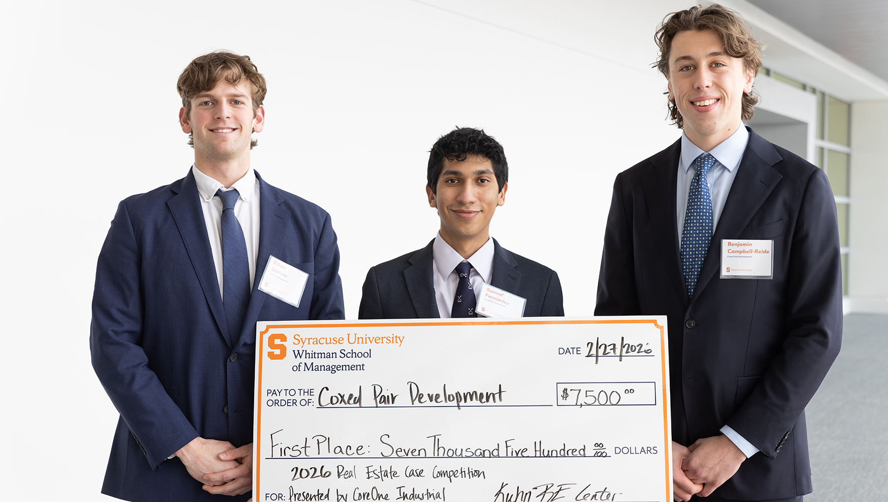 Winning team posing with their oversized check