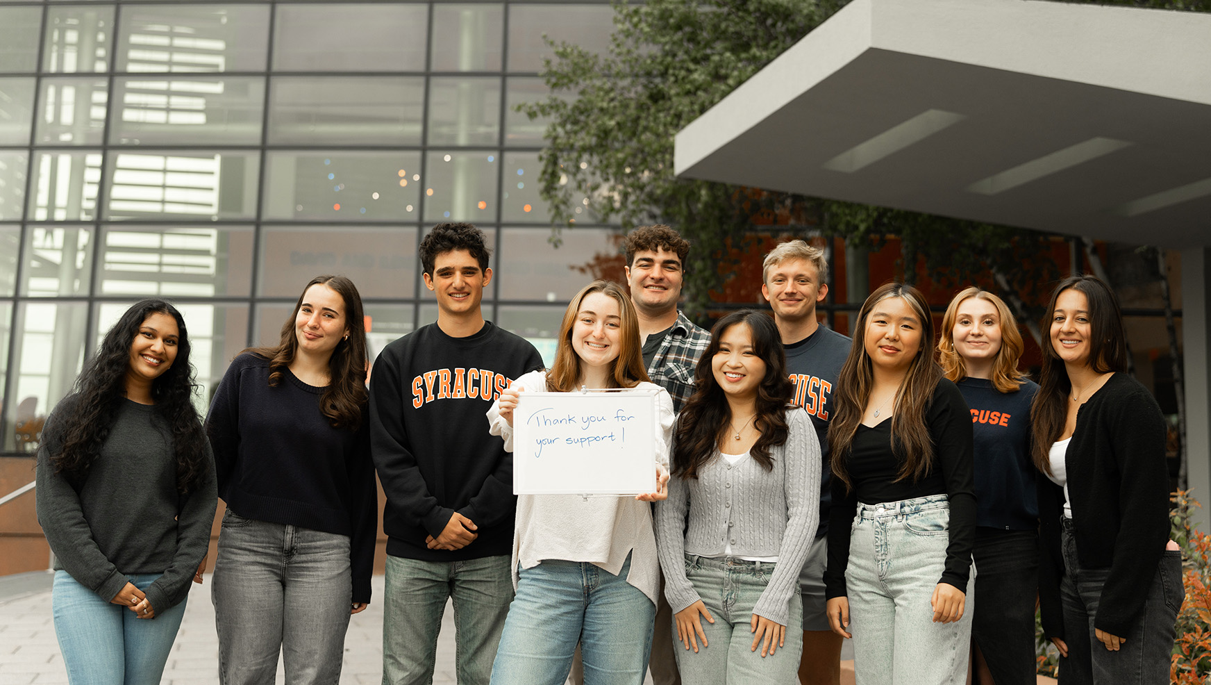 Whitman students holding a Thank you for your Support card.