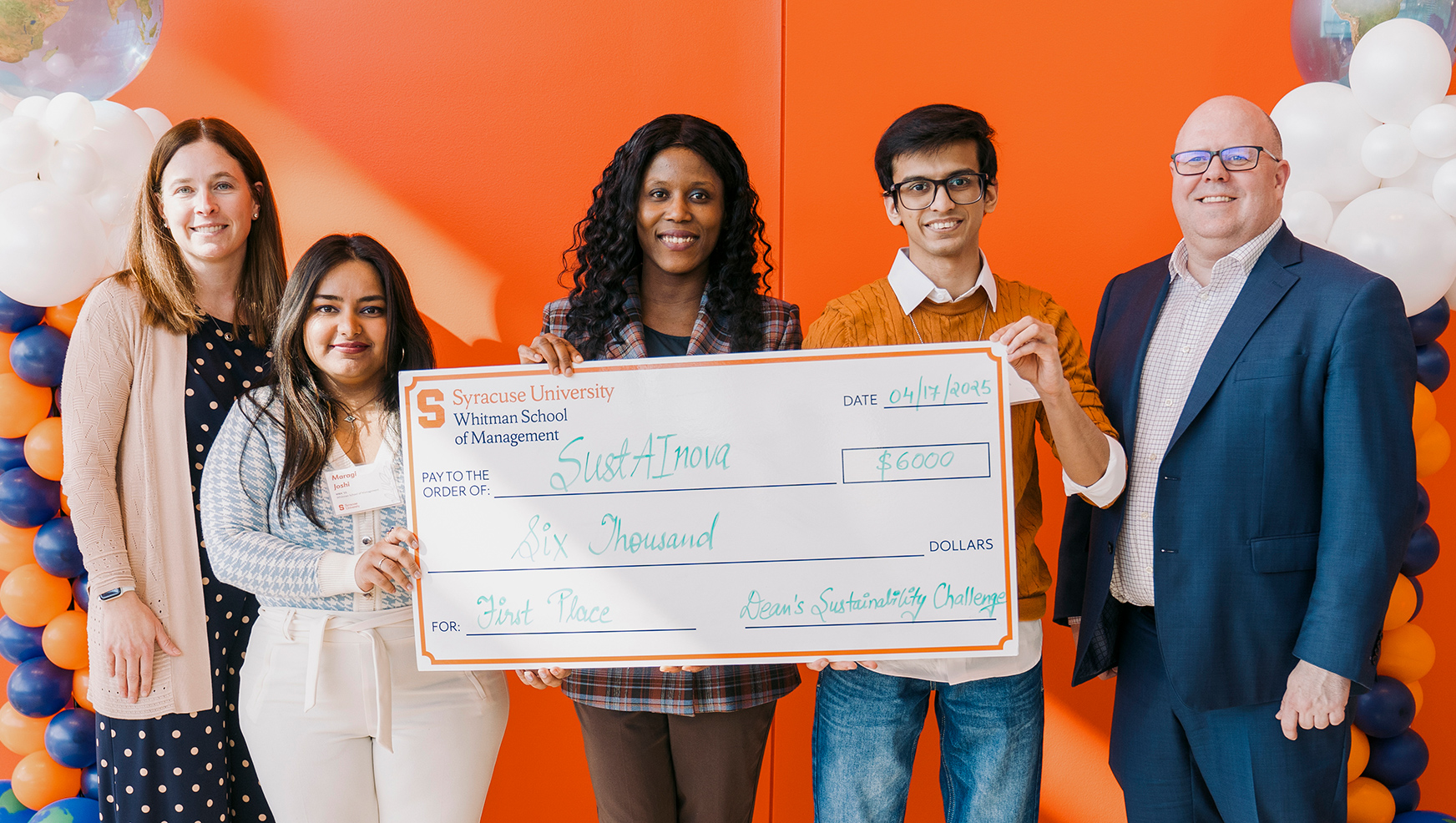 The team members of SustAINova posing with their check next to Erin Draper and Dean McKelvie