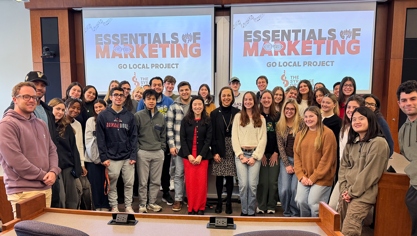 Students in the Essentials of Marketing class posing in classroom