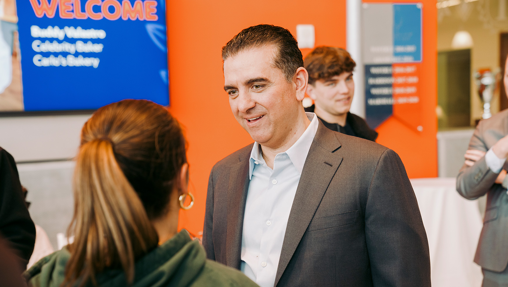 Buddy Valastro talking to a student in Flaum Grand Hall