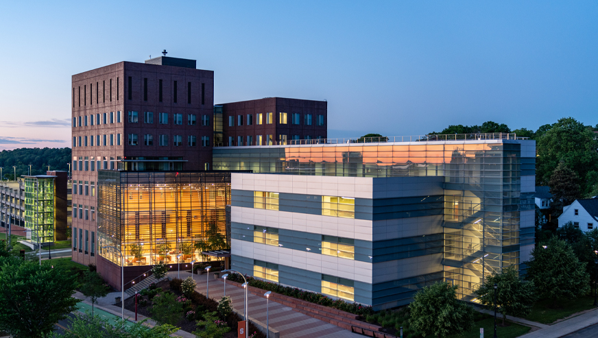 The Whitman School building at dusk