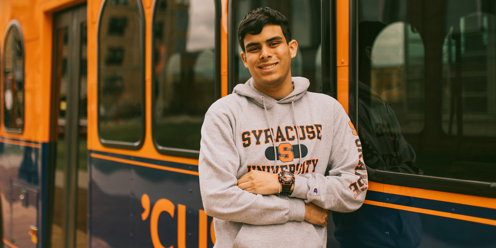 Student in front of Syracuse trolley