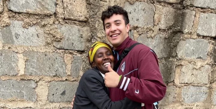 student hugging a woman from kenya