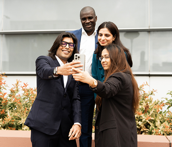 Four graduate students taking a selfie