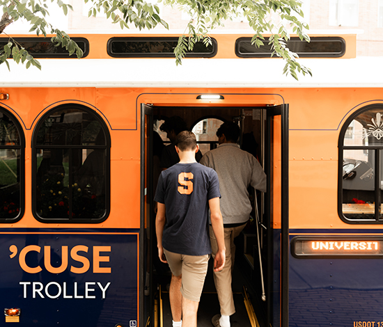 Students walking into a Syracuse University trolley