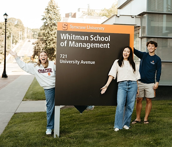 Students outside by Whitman School sign