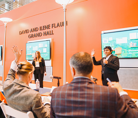 Student presenting in front of judges in Flaum Grand Hall