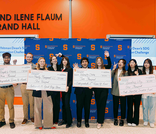 Big group of students posing with their oversized checks